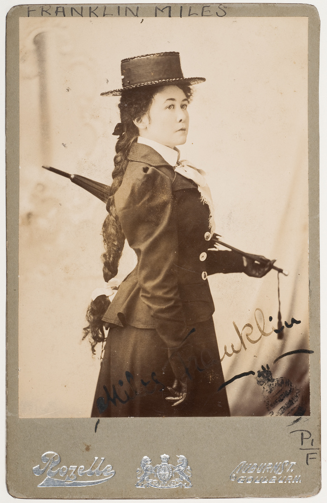 Miles Franklin wielding an umbrella.